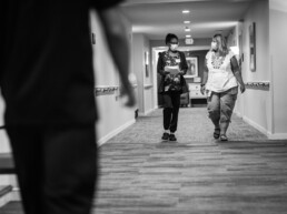 Two female Ecumen employees walking down hall