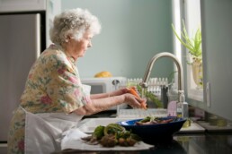 independent living, senior living, senior housing, senior woman washing carrots