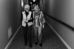 Elderly women walking down hallway