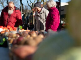 active senior living, independent living, three seniors at farmers market