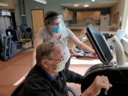 physical therapy, therapy center, female physical therapist working with senior male