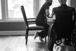 Female care giver, nurse at table with patient