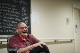 Laughing elderly man in wheel chair