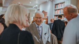 smiling Elderly man socializing at event