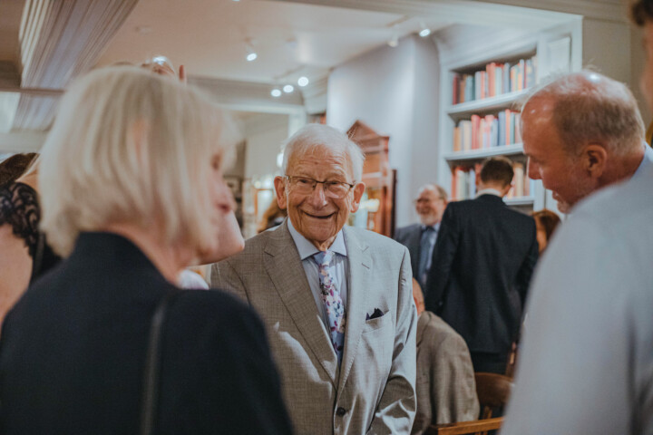 smiling Elderly man socializing at event