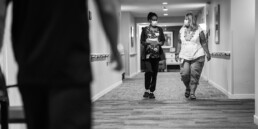 Two female Ecumen employees walking down hall