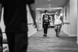 Two female Ecumen employees walking down hall