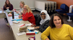 group of Ecumen team members writing Holiday cards to Ecumen residents